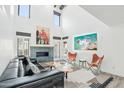 Bright living room with fireplace, statement art, soaring ceilings, and inviting seating at 38953 N 57Th Pl, Cave Creek, AZ 85331