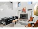 Stylish living room with fireplace, high ceilings, modern furniture, and abundant natural light at 38953 N 57Th Pl, Cave Creek, AZ 85331