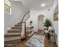 Welcoming home entryway with a curved staircase and decorative details at 3935 E Rough Rider Rd # 1252, Phoenix, AZ 85050