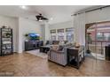 Open living space with tile flooring and bright light from sliding glass doors to balcony at 3935 E Rough Rider Rd # 1252, Phoenix, AZ 85050