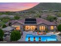Aerial view of the home featuring a beautiful backyard pool with an outdoor seating area and mountain views at 42037 N Bradon Way, Phoenix, AZ 85086