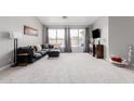 Spacious living room with large windows, neutral carpet, comfortable seating, and contemporary decor at 4292 E Terrace Ave, Gilbert, AZ 85234