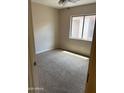 Cozy bedroom with carpet and a window at 43845 W Elizabeth Ave, Maricopa, AZ 85138