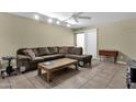 Comfortable living room featuring tile floors, a ceiling fan, and sliding glass doors to the outside at 4549 W Mclellan Rd, Glendale, AZ 85301