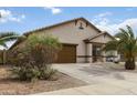 Charming single story house featuring a desert landscaped front yard and a two-car garage at 46185 W Dutchman Dr, Maricopa, AZ 85139