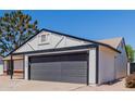 Close-up of exterior elevation showcasing an attached two-car garage and manicured landscaping at 4640 W Gail Dr, Chandler, AZ 85226