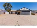 Charming single-story home showcasing a well-maintained facade, desert landscaping and an attached two car garage at 4640 W Gail Dr, Chandler, AZ 85226