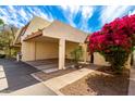 Charming desert home featuring a two car carport, walkway, and vibrant bougainvillea at 5208 S Deborah Dr, Tempe, AZ 85283