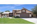 Inviting two-story home with a well-maintained lawn and a spacious two-car garage at 6101 W Grandview Rd, Glendale, AZ 85306