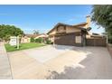 Inviting home with a spacious driveway, manicured lawn, and a charming pergola covered entrance at 6101 W Grandview Rd, Glendale, AZ 85306