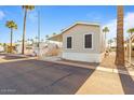 Exterior view of a charming single-story home featuring desert landscaping and covered parking at 7807 E Main St # F36, Mesa, AZ 85207