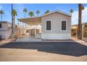 Charming single-story home with covered parking and palm trees at 7807 E Main St # F36, Mesa, AZ 85207