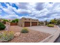Southwestern home features desert landscaping, a spacious driveway, and two-car garage at 9938 E Little Nugget Way, Gold Canyon, AZ 85118