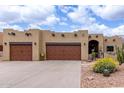 Stunning Santa Fe-style home with desert landscaping and spacious two-car garage at 9938 E Little Nugget Way, Gold Canyon, AZ 85118