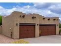 Tuscan-style home features desert landscaping and spacious two-car garage at 9938 E Little Nugget Way, Gold Canyon, AZ 85118
