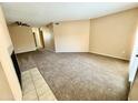 Spacious carpeted living room offering a ceiling fan and bright natural light at 11640 N 51St Ave # 248, Glendale, AZ 85304
