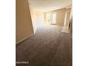 Bright living room with new carpeting, neutral paint, and access to a private balcony at 11640 N 51St Ave # 248, Glendale, AZ 85304