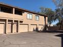 Townhouse exterior featuring garages and private entrances in a well-maintained complex at 1406 W Emerald Ave # 124, Mesa, AZ 85202