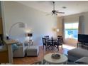 Bright living space with laminate floors, dining area and a large window with natural light at 1341406 W Emerald Ave # 124, Mesa, AZ 85202