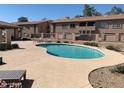 Community pool surrounded by a concrete deck, perfect for relaxation and leisure at 1406 W Emerald Ave # 124, Mesa, AZ 85202