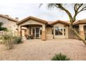 Back exterior with covered patio, seating and views of desert landscaping offering an ideal outdoor living space at 14000 N 94Th St # 1031, Scottsdale, AZ 85260