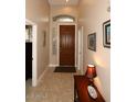 Inviting entryway featuring tiled flooring, a decorative table, and arched transom for a warm welcome at 14000 N 94Th St # 1031, Scottsdale, AZ 85260