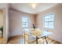 Cozy dining room with wooden table, four chairs, natural light, and hardwood floors at 1551 W Vernon Ave, Phoenix, AZ 85007