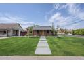 Inviting brick home with a modern walkway and well-manicured lawn, creating a welcoming entrance at 1551 W Vernon Ave, Phoenix, AZ 85007