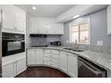 Updated kitchen with granite countertops, modern appliances, and sleek white cabinetry at 1654 S 77Th St, Mesa, AZ 85209