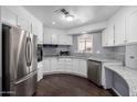 Bright kitchen featuring stainless steel appliances, granite counters, and wood-look floors at 1654 S 77Th St, Mesa, AZ 85209