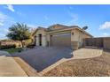 Beautiful home featuring a paver driveway, desert landscaping, and great curb appeal on a sunny day at 20765 E Raven Dr, Queen Creek, AZ 85142