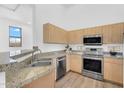 Well-equipped kitchen with stainless steel appliances, granite countertops, and ample cabinet space at 20801 N 90Th Pl # 271, Scottsdale, AZ 85255