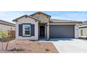 Beautiful home showcasing a stone facade, two-car garage, and desert landscaping at 23417 W Burton Ave, Buckeye, AZ 85326