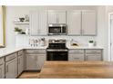 Modern kitchen featuring gray cabinets, stainless steel appliances, and stylish countertop decor at 23417 W Burton Ave, Buckeye, AZ 85326