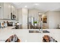 Contemporary kitchen with white counters, stainless steel appliances, and an open layout at 23417 W Burton Ave, Buckeye, AZ 85326