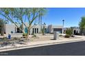 Single story home with desert landscaping and a beautiful blue front door at 2426 E Turquoise Dr, Phoenix, AZ 85028