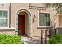Charming front entrance with an arched doorway, colorful accents, and manicured greenery at 2660 S Equestrian Dr # 103, Gilbert, AZ 85295