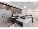 Well-lit kitchen with stainless steel appliances, a center island, and a view into the living space at 2660 S Equestrian Dr # 103, Gilbert, AZ 85295
