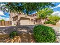 Spacious two-story home with multiple garage spaces, complemented by well-kept landscaping and a paved driveway at 26853 N 89Th Dr, Peoria, AZ 85383