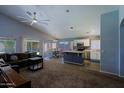 Open-concept living space featuring modern ceiling fan, adjacent dining area and kitchen with an island at 287 W Liberty Ln, Gilbert, AZ 85233