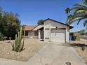 Charming single-story home featuring a well-maintained yard and attached garage in quiet neighborhood at 3002 W Tonopah Dr, Phoenix, AZ 85027