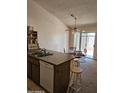 Eat-in kitchen area featuring an island, dining table, barstool seating and access to the backyard at 3002 W Tonopah Dr, Phoenix, AZ 85027