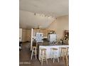 Bright eat-in kitchen featuring an island, updated lighting, modern appliances, and lots of cabinet space at 3002 W Tonopah Dr, Phoenix, AZ 85027
