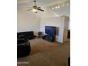 Cozy living room featuring vaulted ceilings, a ceiling fan, natural lighting and neutral colored carpet at 3002 W Tonopah Dr, Phoenix, AZ 85027