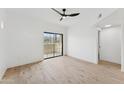 Bright bedroom features sleek ceiling fan, wood floors, and a large window with beautiful mountain views at 3434 E Baseline Rd # 265, Phoenix, AZ 85042