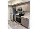 Kitchen features stainless steel appliances, granite countertops and gray cabinets at 3810 N Maryvale Pkwy # 2061, Phoenix, AZ 85031
