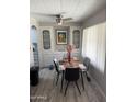 Bright dining area with neutral decor, contemporary ceiling fan, ample natural light, and built-in shelving at 4065 E University Dr # 242, Mesa, AZ 85205