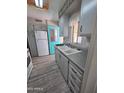Efficient kitchen features light gray cabinets, modern countertops, and white appliances at 4065 E University Dr # 242, Mesa, AZ 85205
