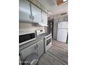 Well-equipped kitchen boasts a microwave, oven, and a refrigerator at 4065 E University Dr # 242, Mesa, AZ 85205