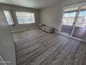 Bright living room featuring laminate flooring and sliding glass door at 4065 E University Dr # 242, Mesa, AZ 85205